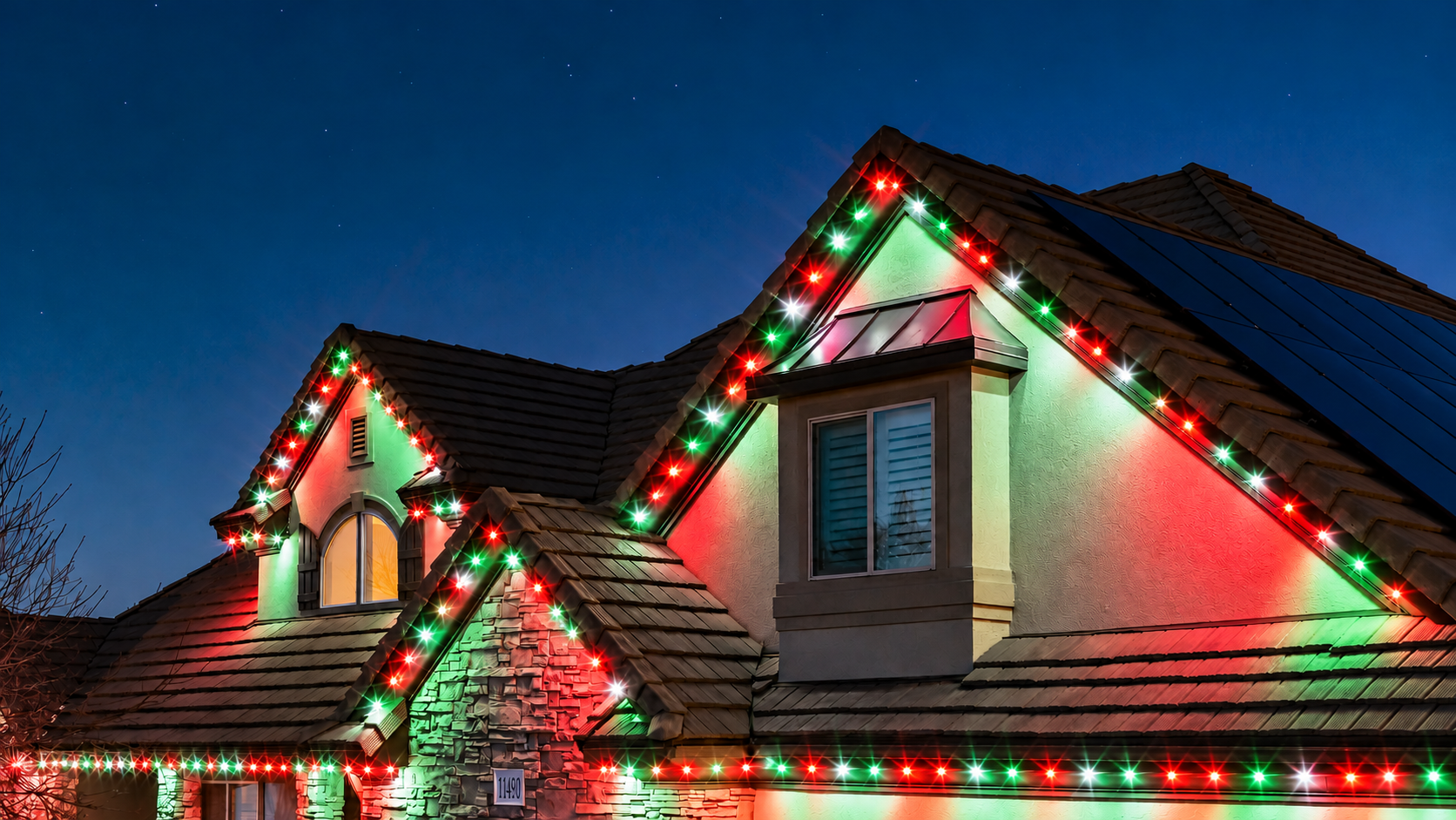 Trimlight permanent lights set for Christmas, shown on an example home
